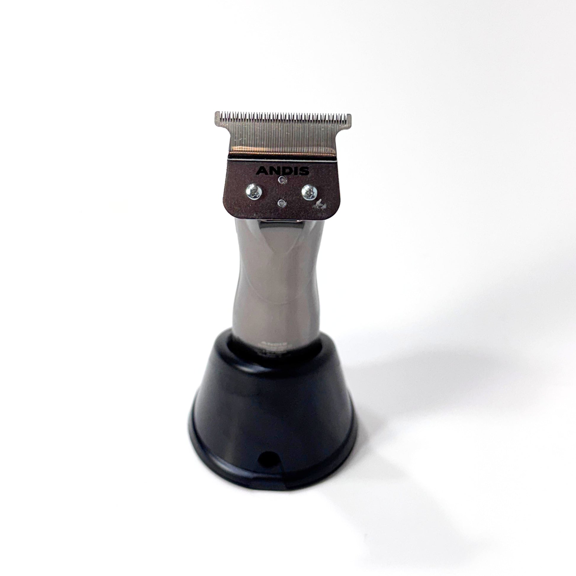 Andis Slimline gtx trimmer on charging stand blade view